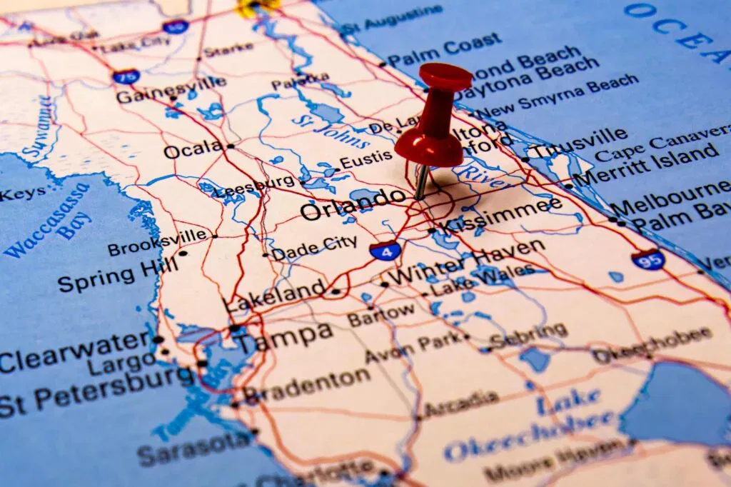 Close-up shot of a red push pin marking the city of Orlando on a map of Florida, highlighting the local service area.